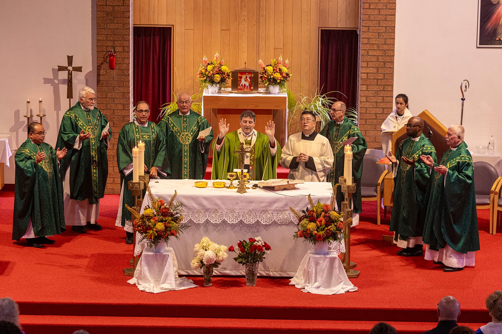 All the priests and cardinal praying the Our Father at the 150th anniversary mass at St Paul's church.